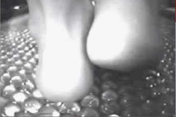 image of foot on glass pebbles